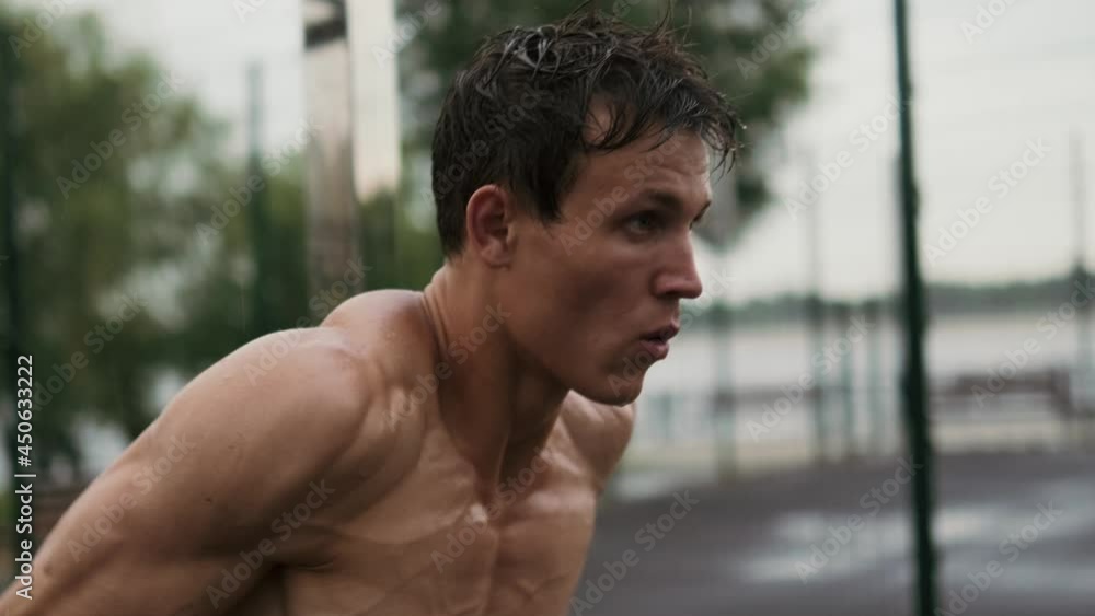 A strong guy is training outdoors at the sports-ground A strong guy is training outdoors at the sports-ground