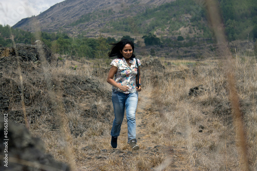 Happy free Asia woman running in the mountains. Happiness and freedom lifestyle inspiraitonal concept. photo