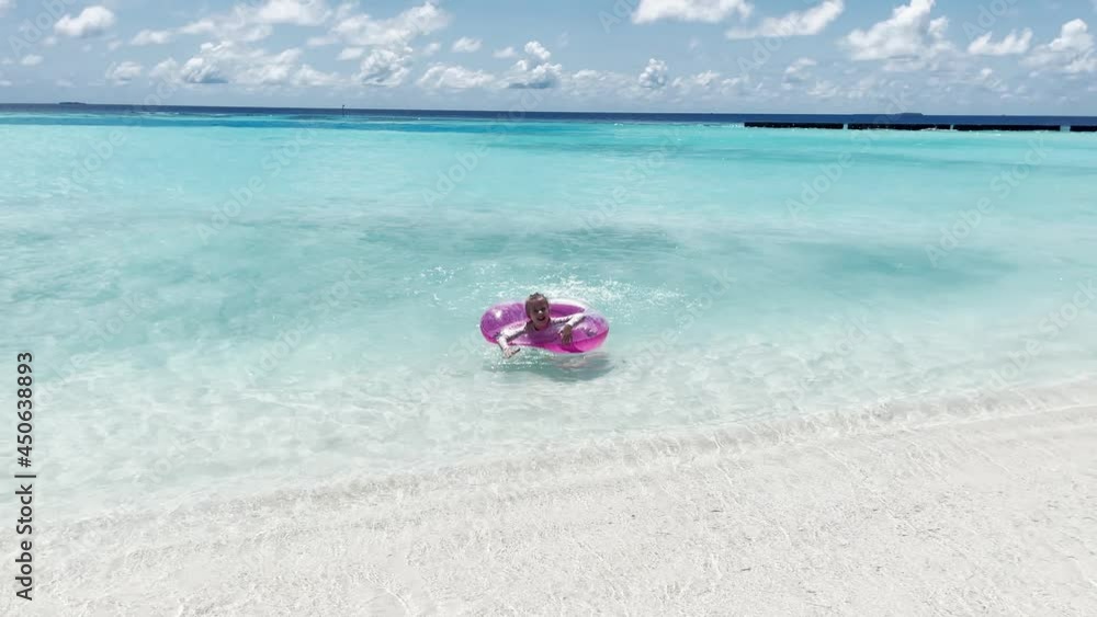 Little girl playing on the ocean beach Little girl playing on the ocean beach
