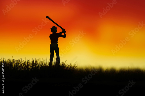 Miniature people toy figure photography. Silhouette of women golfer swing his stick at meadow field hill when sunset sunrise