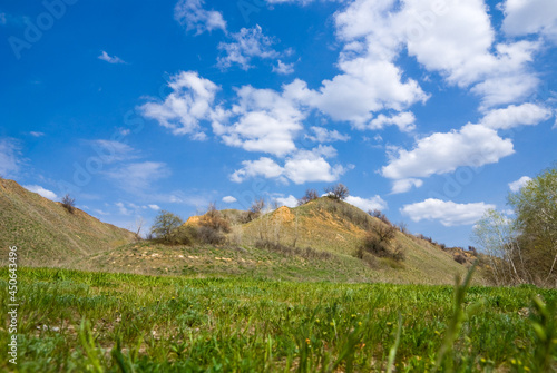 Yellow hills under blue sky with clouds