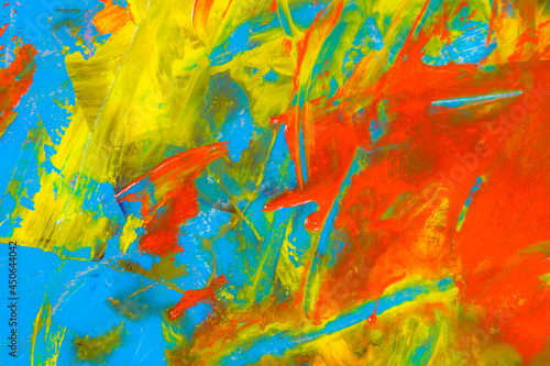 colorful creative motley background  smudged residues of oil paints on a wooden palette  short focus  selective blur