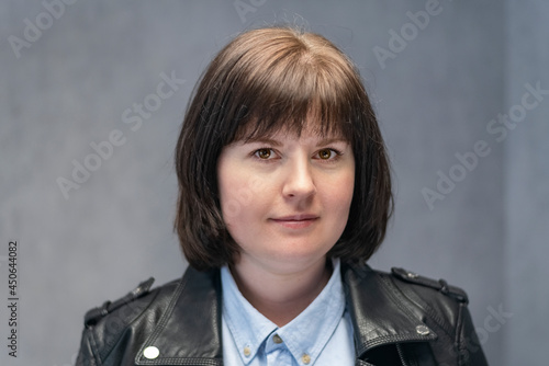 Fotobehang Portrait of young woman with bob haircut in leather jacket
