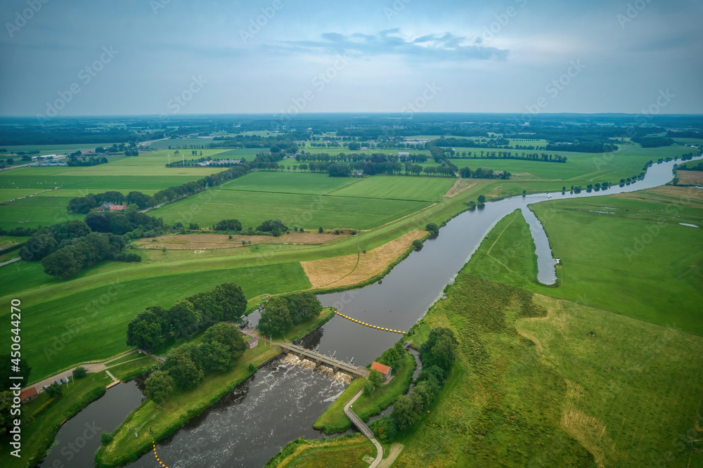 Airial view of a weir in the river Vecht. Dutch river in a colorful landscape. Water authority Drents Delta Overijssel
