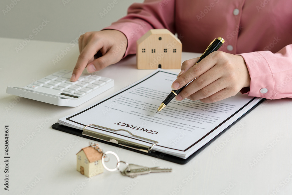 Fototapeta premium Real estate broker agent presenting and consult to customer to decision making sign insurance form agreement, buy and sell home model, concerning mortgage loan offer for and house insurance