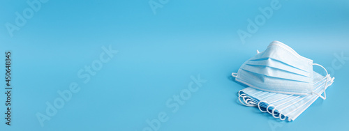 medical face masks on blue background. banner photo