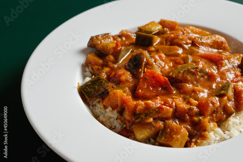 Eggplant curry with tomatoes, served in a plate.
