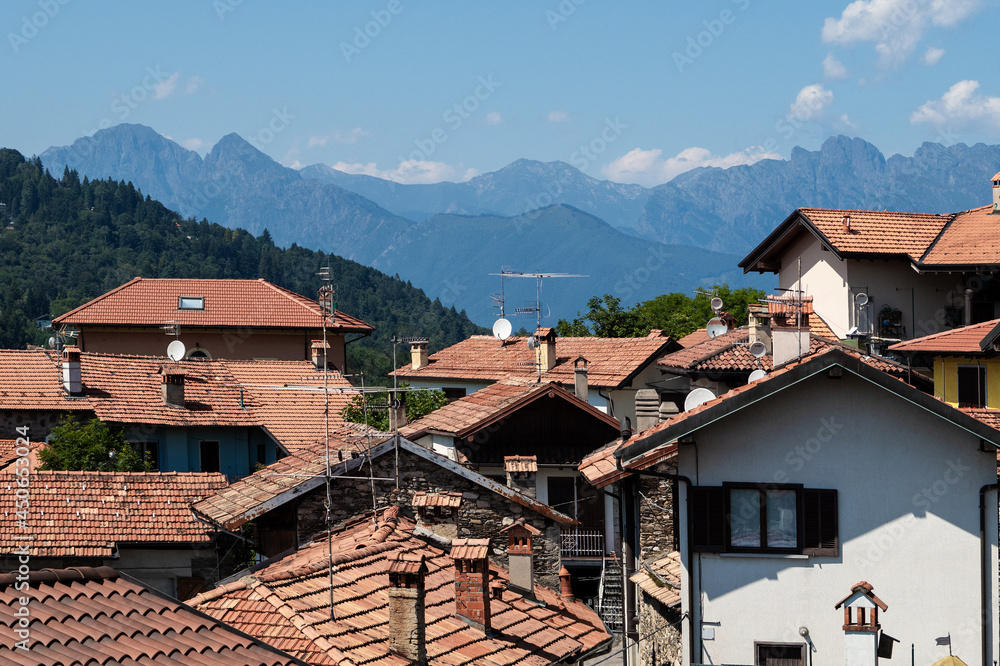 Alpine village with mountain range in the background, tourist destination in the summer months.Piedmont, Italy.