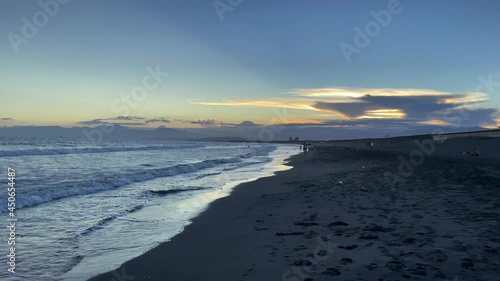 FUJISAWA, KANAGAWA, JAPAN - JULY 2021 : View of beach and magic hour sky at Shonan area near Enoshima island. Wide view, real time shot in dusk. photo