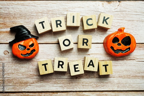 Trick or Treat alphabet letter with Halloween decoration on wooden background