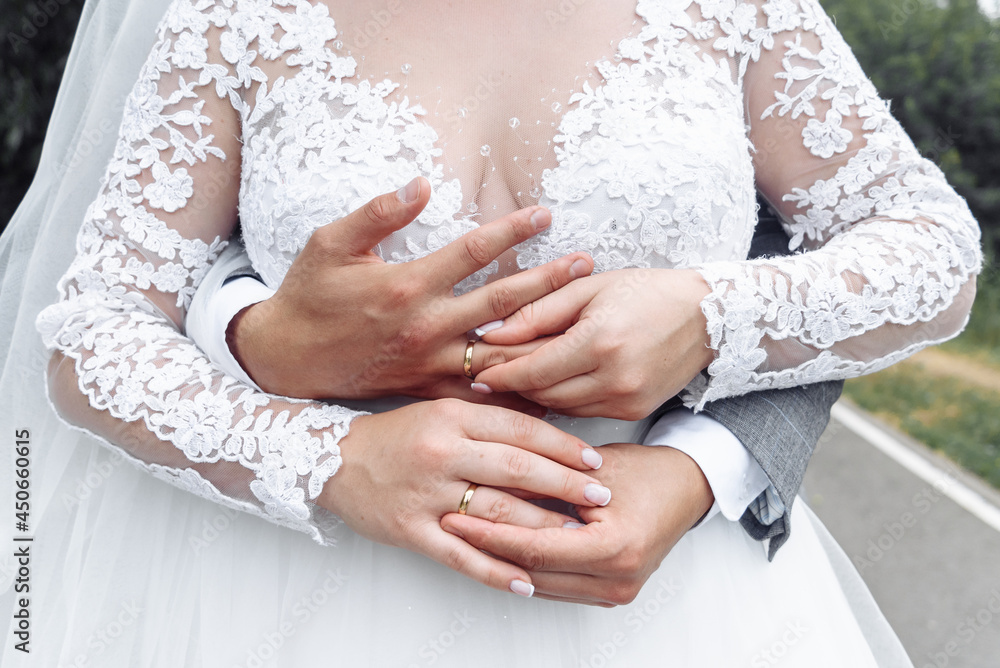 hands of young people with wedding wedding rings. wedding day details. calla flowers. spouses newlyweds groom and bride hands of young people with wedding wedding rings. wedding day details. calla flowers. spouses newlyweds groom and bride