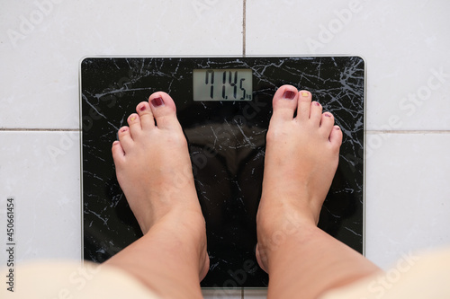 Top view picture of foot on body weight scale photo