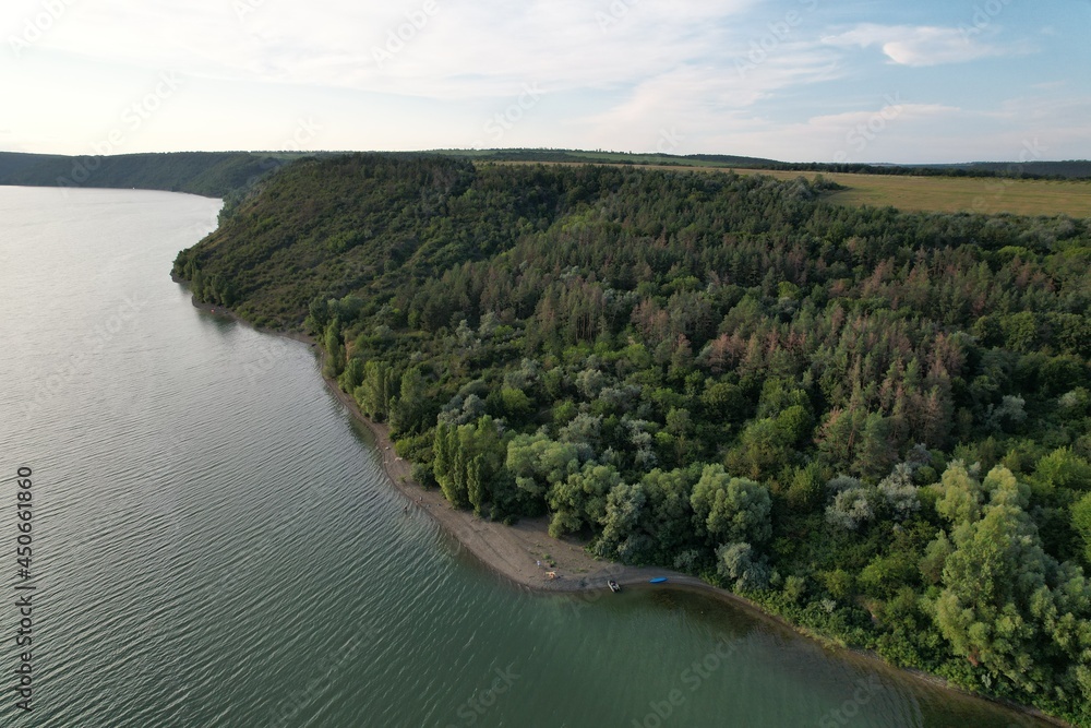 Aerial panoramic view of huge river, green pine forest near the river. Summer morning. Panoramic landscape. Aerial panoramic view of huge river, green pine forest near the river. Summer morning. Panoramic landscape.