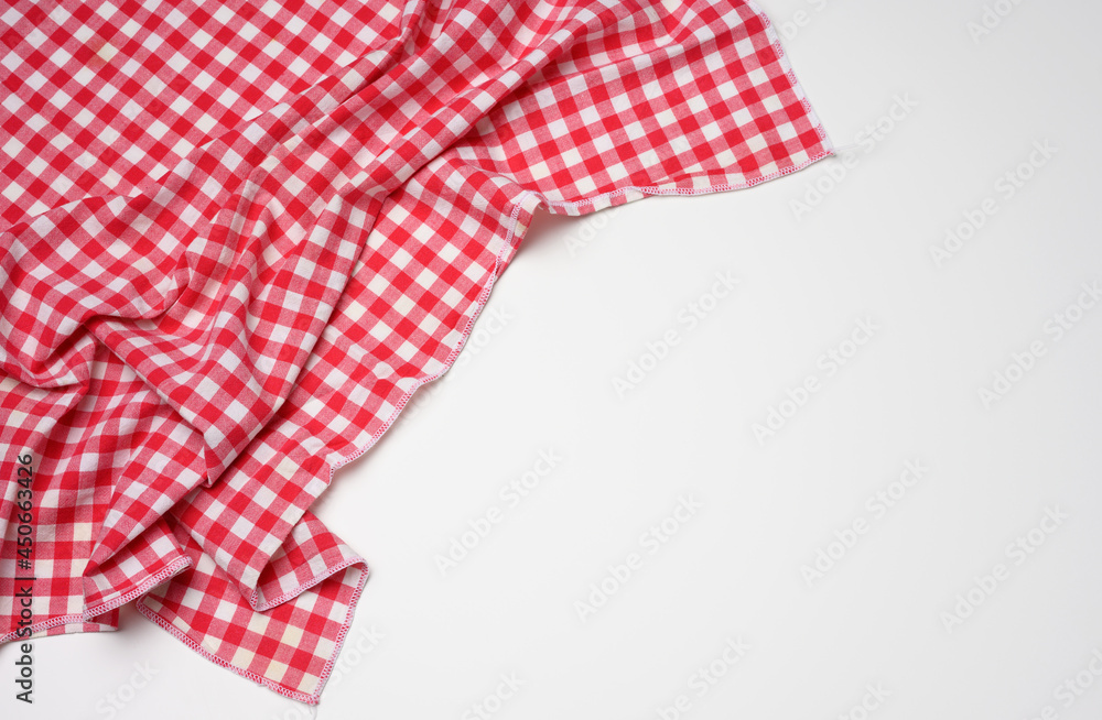 folded cotton red white checkered napkin on a white background folded cotton red white checkered napkin on a white background