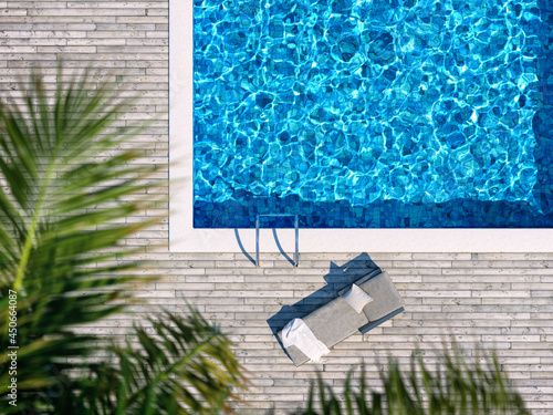 Swimming pool with wooden deck and chaise lounge Fototapeta