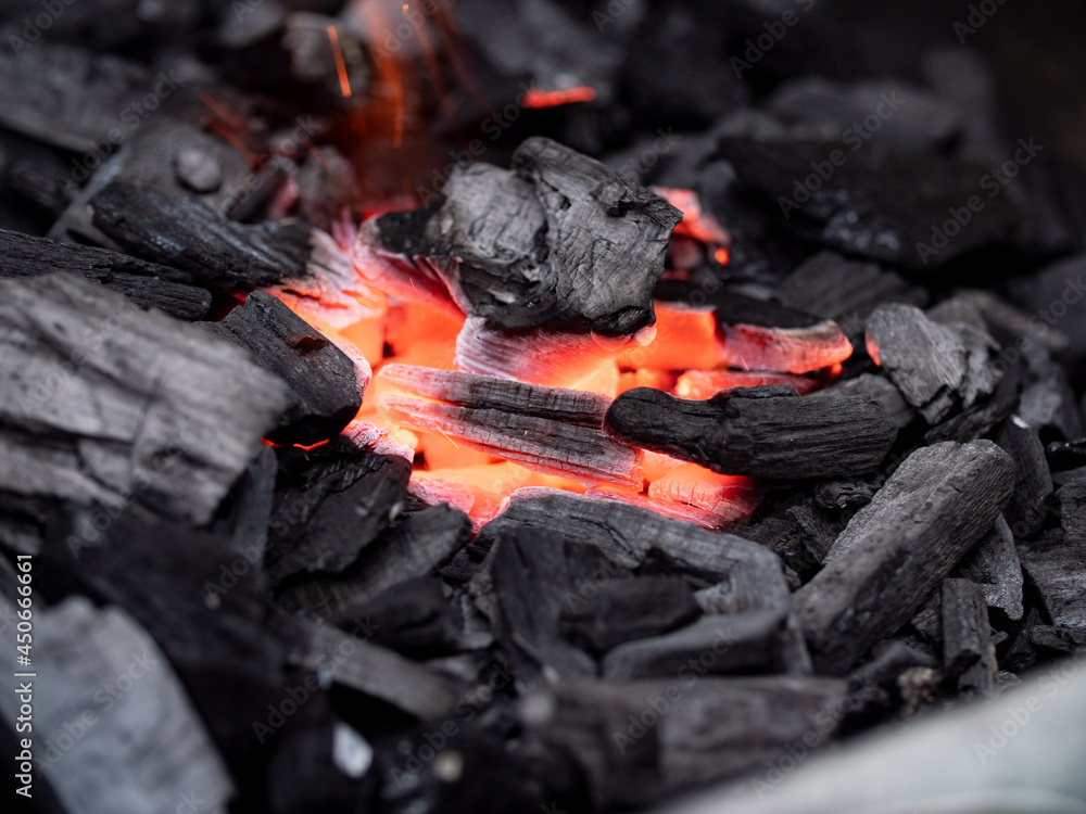 Close-up of orange glowing embers of charcoal. Barbecue in the garden. Close-up of orange glowing embers of charcoal. Barbecue in the garden.