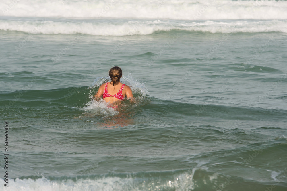 beautiful young woman having fun in the waves beautiful young woman having fun in the waves