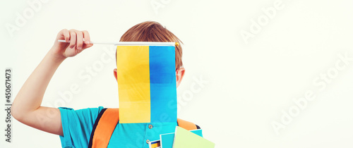School boy learning ukrainian language. Celebration ukraine holidays. Child holding ukrainian flag.