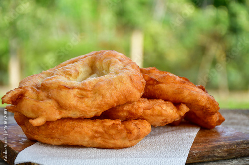 Traditional Bulgarian home made deep fried  patties  covered with sugar  оn rustic backgroud.Mekitsa or Mekica,  on wooden  rustic  background. Made of kneaded dough that is deep fried  photo