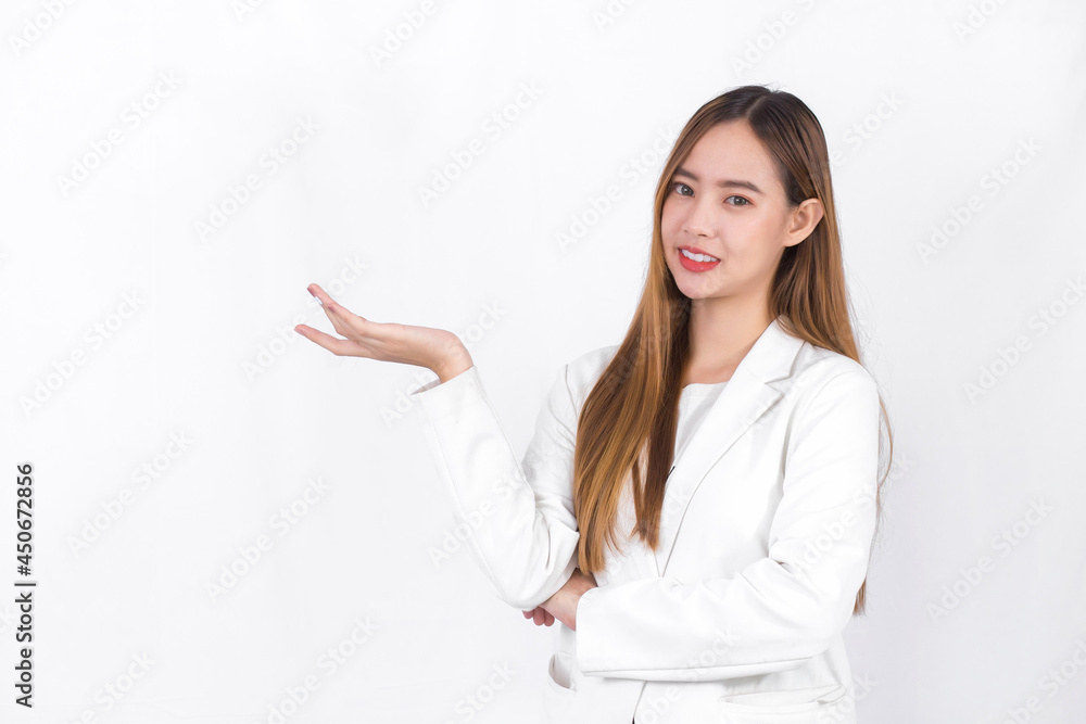 Asian professional woman with bronze long hair wearing a white suit and pretty smiling is present product on white background. Asian professional woman with bronze long hair wearing a white suit and pretty smiling is present product on white background.