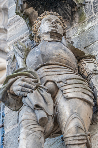 Ancient statue portrait of Saint Maurice (black Knight) as gatekeeper in Magdeburg Cathedral as Roman soldier from Thebes of 13 century, Magdeburg, Germany, closeup, details