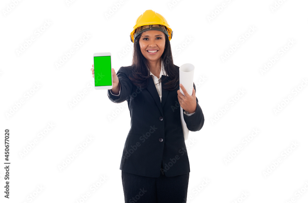 portrait of mixed race asian/caucasian engineer woman with helmet holding blueprints and showing green screen mobile phone isolated white background portrait of mixed race asian/caucasian engineer woman with helmet holding blueprints and showing green screen mobile phone isolated white background
