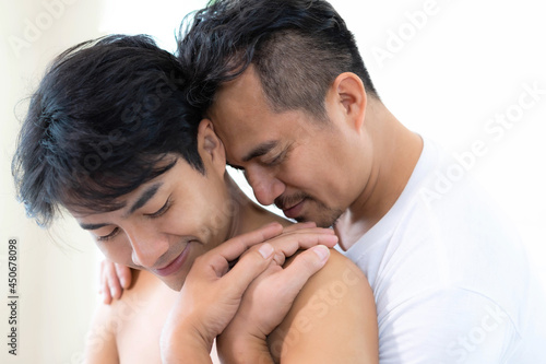 Asian love gay couple homosexual hugging , couple man and man relaxing in bed room -LBGT Gay Couple Love Home Concept