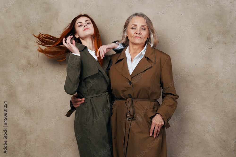 Mom and daughter in autumn coat fashion posing lifestyle Mom and daughter in autumn coat fashion posing lifestyle