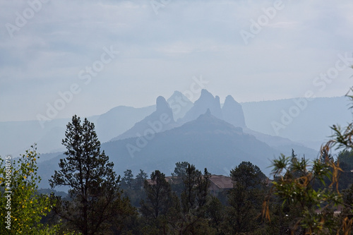 Fire in the distance in Oak Creek Canyon, Arizona during daylight photo