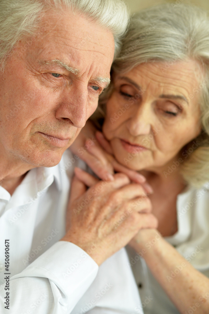Close up portrait of sad senior couple