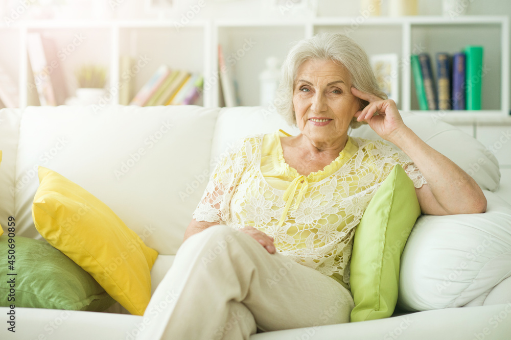 Happy beautiful senior woman posing at home Happy beautiful senior woman posing at home