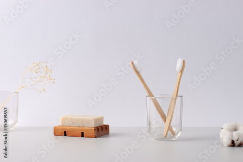 Zero waste, sustainable and eco-friendly lifestyle. Soap, toothbrush with flowers on white background. Close up, copy space