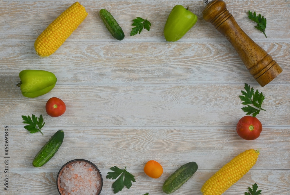 food and culinary background with copy space for text top view, pepper mill, pink himalayan salt and cooking ingredients, fresh vegetables tomatoes, cucumbers on the kitchen wooden table food and culinary background with copy space for text top view, pepper mill, pink himalayan salt and cooking ingredients, fresh vegetables tomatoes, cucumbers on the kitchen wooden table