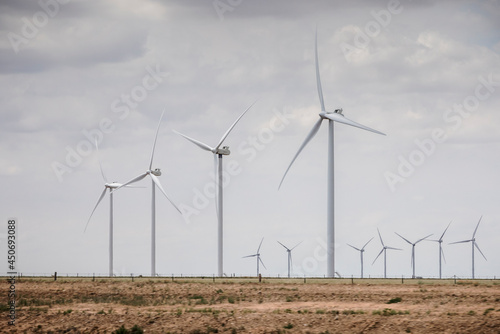 фотографія Wind turbines generate electricity near farms in West Texas.