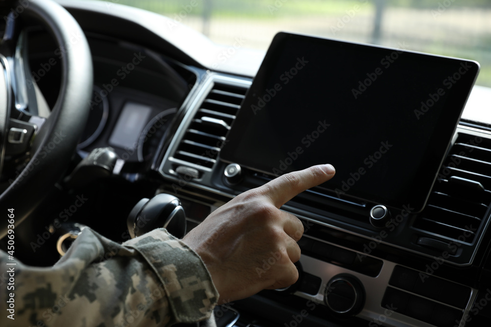 Soldier using tablet in car, closeup view