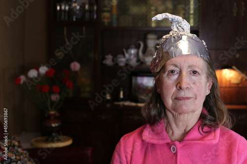 Senior conspiracy theorist wearing weird hat