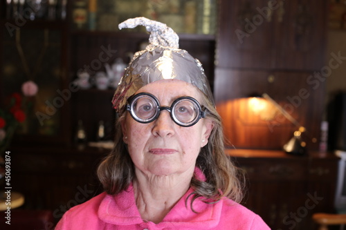 Senior conspiracy theorist wearing weird hat  photo