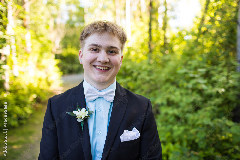 Portrait of happy handsome young man wearing suit.
