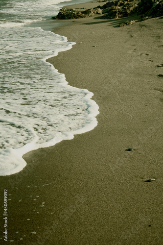 A sinuous ocean wave penetrates the sandy shore. Mojacar Beach, Almeria