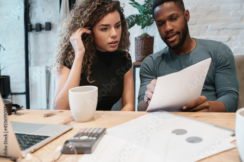 Photography Young couple planning monthly budget together.