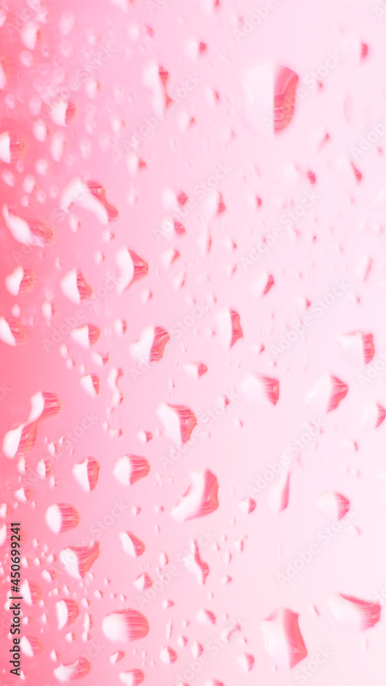 Close focus on water drop on colorful glass. Vertical mobile format for smartpone stories. Close focus on water drop on colorful glass. Vertical mobile format for smartpone stories.