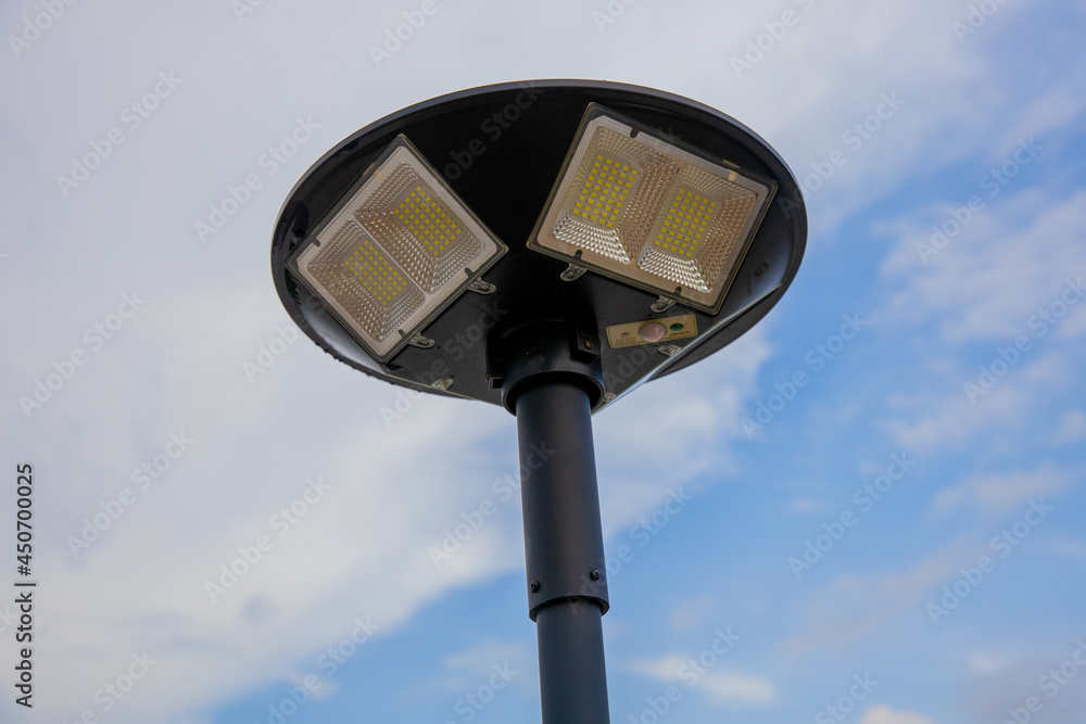 Public city light with solar panel powered on blue sky with cloud Public city light with solar panel powered on blue sky with cloud