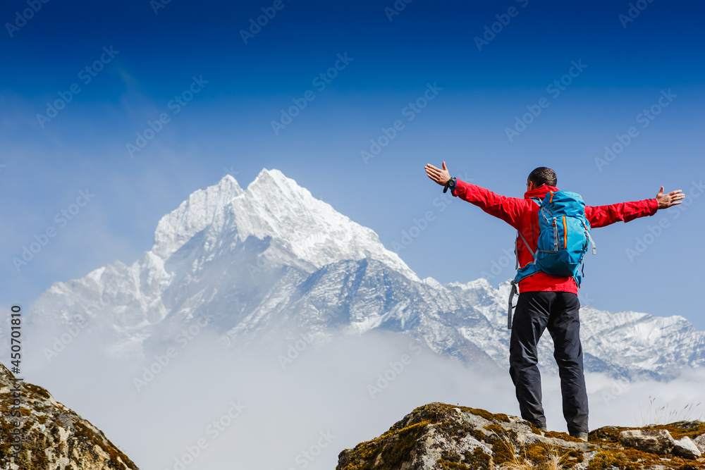 Hiker enjoying the view on the Everest trek in Himalayas, Nepal Hiker enjoying the view on the Everest trek in Himalayas, Nepal