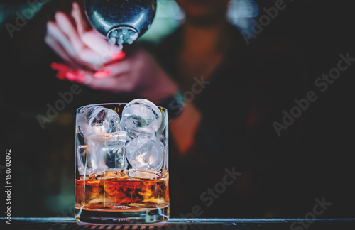 Photography bartender making Cuba Libre cocktail in bar