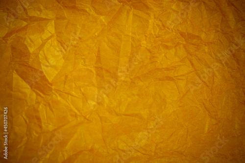 Crumpled gold paper recycling background.