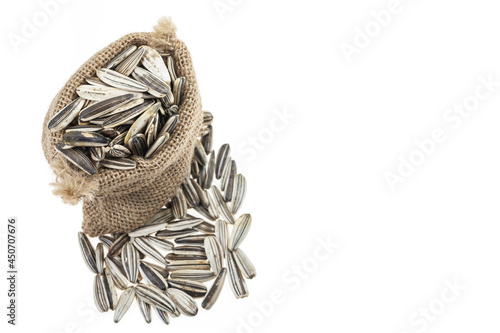 Fotografie Sunflower seeds in sacks on white background