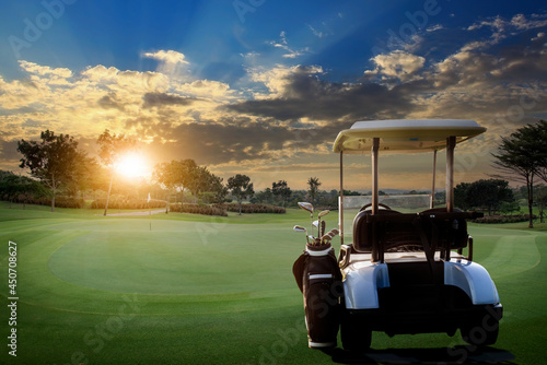 Fotografie A golf cart parking on road at golf course with beautiful twilight sky background, summer color style