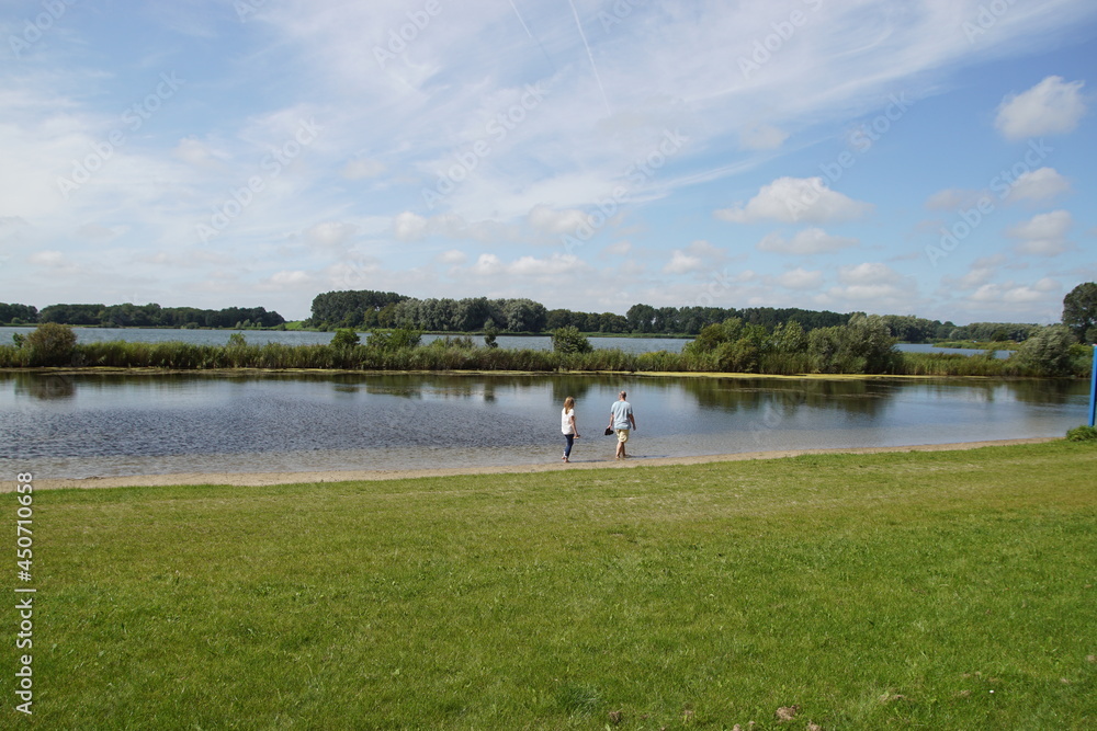 Fototapeta premium View of the lake from the Geestmerambacht recreation area near the Dutch city of Alkmaar. Netherlands, Summer, August, 