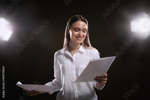 Fototapeta Professional actress reading her script during rehearsal in theatre
