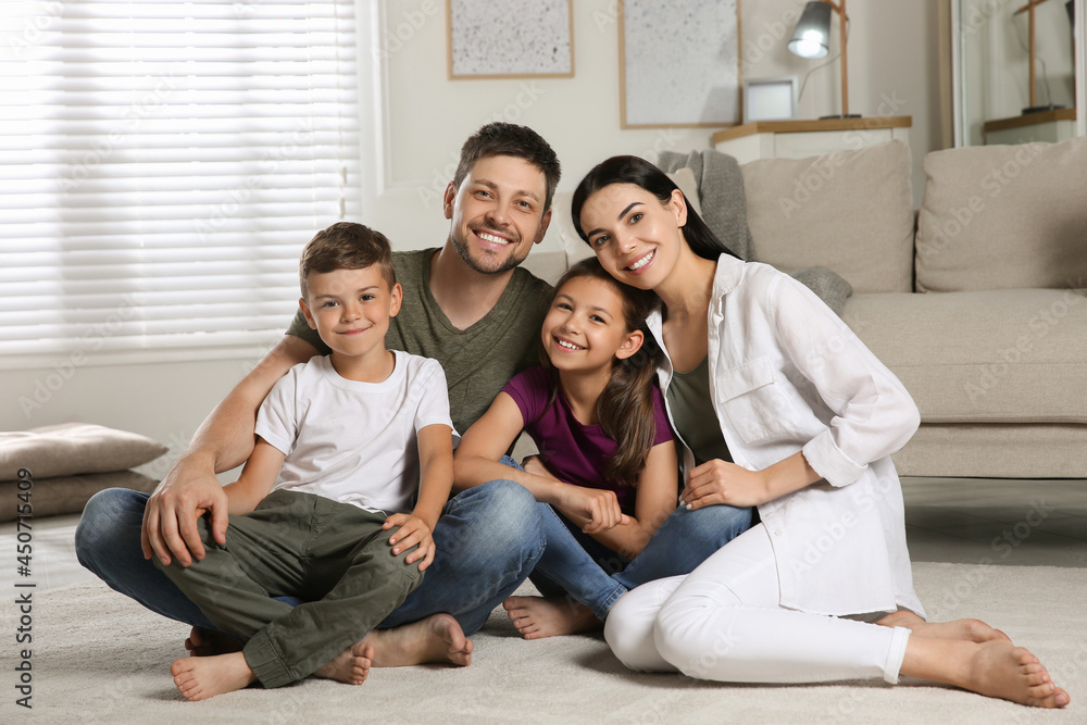 Portrait of happy family in living room. Adoption concept
